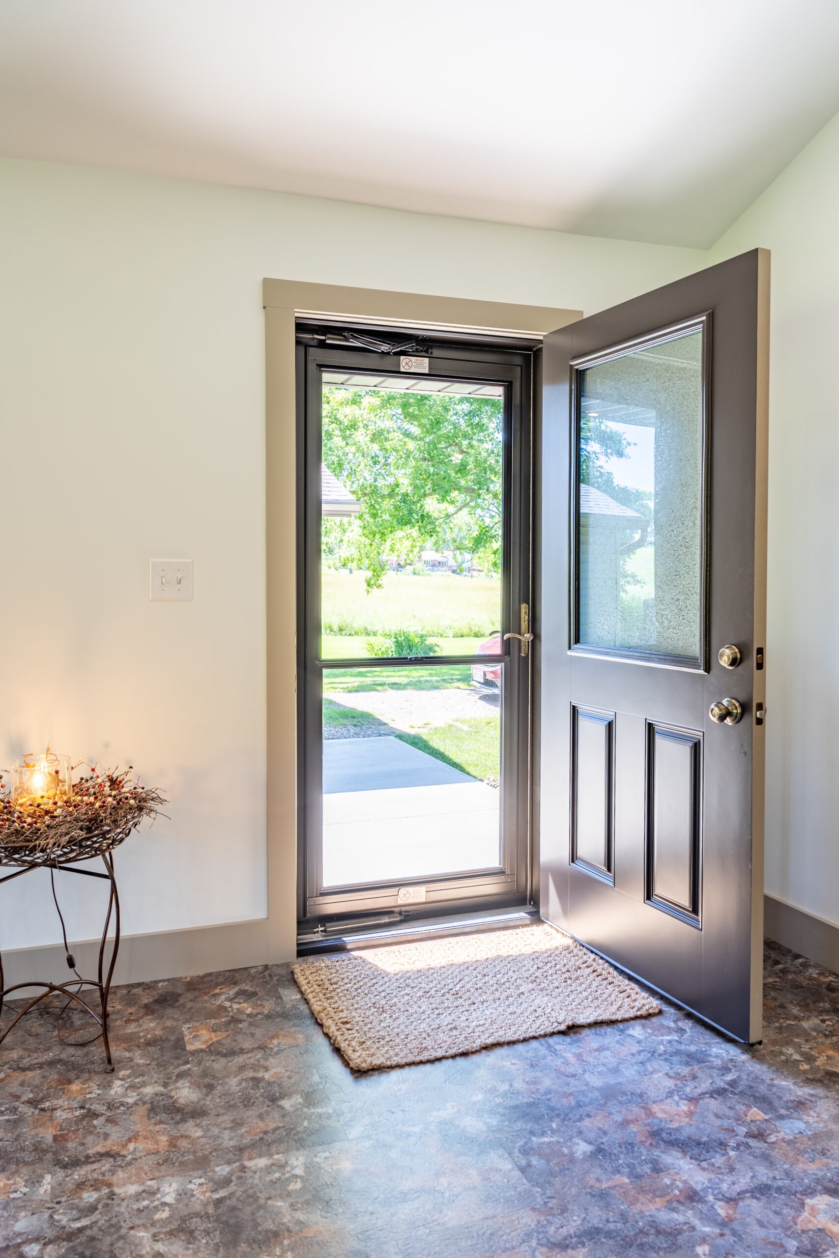 Interior view of high-performance ProVia Aeris casement windows with dark architectural frames and energy-efficient glass reflecting a local North Carolina landscape.