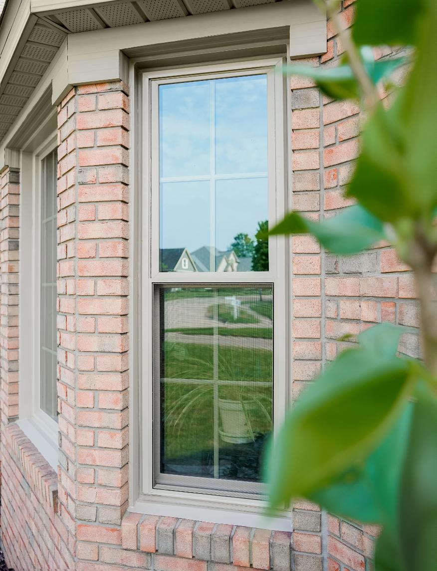Installer measuring uneven living room window opening during Thomasville home update