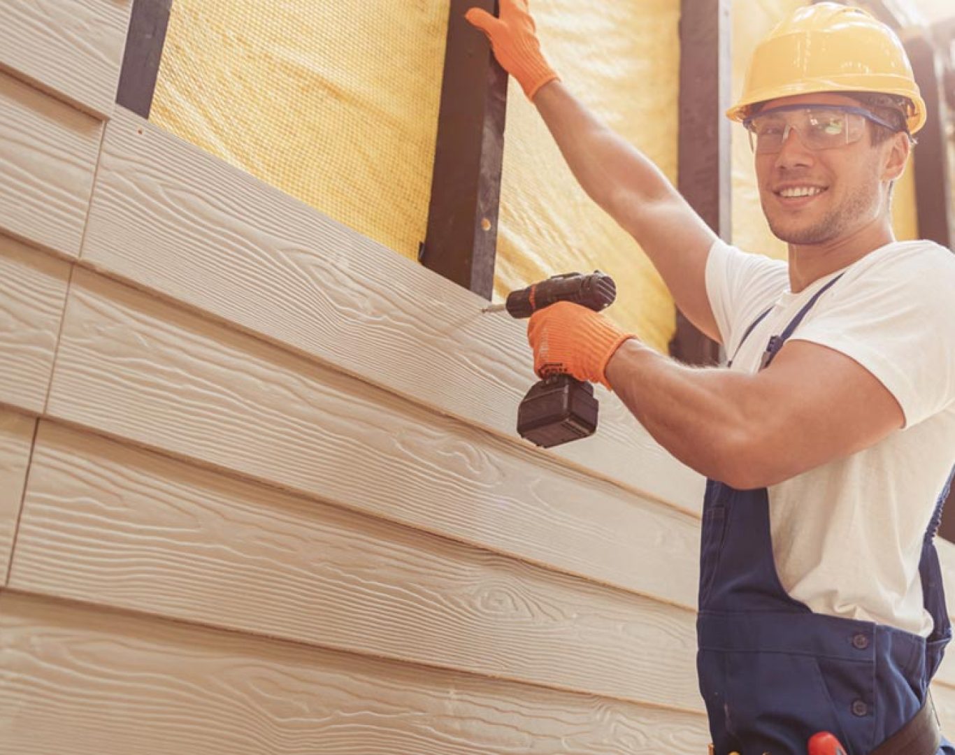 Siding Contractor in Cornelius - NC inspecting wall sheathing before installing new exterior panels