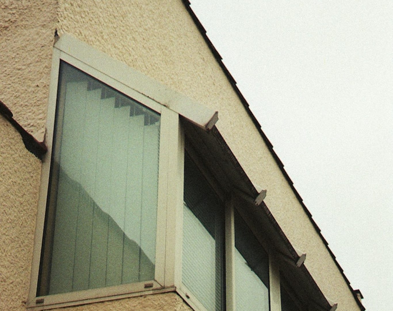brown concrete building with green window